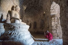 Mrauk U, MYANMAR - 13 dicembre 2014: Giovane neofita che prega in un Bu immagine stock libera da diritti Mrauk U, MYANMAR - 13 dicembre 2014: Giovane neofita che prega in un Bu immagine stock libera da diritti