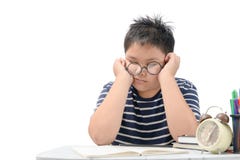 Muchacho cansado del estudiante con los vidrios que duerme en los libros foto de archivo Muchacho cansado del estudiante con los vidrios que duerme en los libros foto de archivo