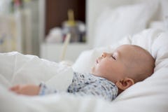 Muchacho enfermo del niño que miente en cama con una fiebre, descansando en casa imagen de archivo libre de regalías Muchacho enfermo del niño que miente en cama con una fiebre, descansando en casa imagen de archivo libre de regalías