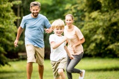 Muchacho feliz que compite con a su familia Imagenes de archivo Muchacho feliz que compite con a su familia Imagenes de archivo