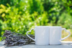 Mugs for lovers. Two romantic cups. Two white cups with hearts Royalty Free Stock Photo Mugs for lovers. Two romantic cups. Two white cups with hearts Royalty Free Stock Photo