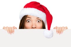 Mujer del sombrero de Santa que muestra la muestra de la Navidad fotografía de archivo libre de regalías Mujer del sombrero de Santa que muestra la muestra de la Navidad fotografía de archivo libre de regalías