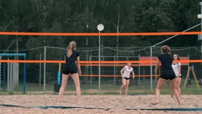 Mujer joven que juega a voleibol en la playa en un equipo que realiza un ataque que golpea la bola Muchacha en golpes de la cámar metrajes Mujer joven que juega a voleibol en la playa en un equipo que realiza un ataque que golpea la bola Muchacha en golpes de la cámar metrajes