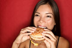 Mujer que come la hamburguesa imagen de archivo libre de regalías Mujer que come la hamburguesa imagen de archivo libre de regalías