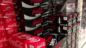 Mujer que toma una caja de Coca-Cola light Mujer que toma una caja de Coca-Cola light
