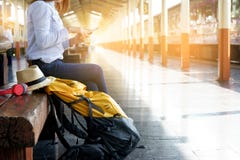 mulher com sua trouxa que senta-se no estação de caminhos-de-ferro fotografia de stock mulher com sua trouxa que senta-se no estação de caminhos-de-ferro fotografia de stock