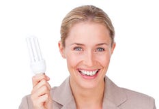 Mulher de negócios que prende uma ampola da energia da economia fotografia de stock Mulher de negócios que prende uma ampola da energia da economia fotografia de stock