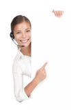Mulher dos auriculares no centro de chamadas que está no quadro de avisos imagem de stock royalty free Mulher dos auriculares no centro de chamadas que está no quadro de avisos imagem de stock royalty free