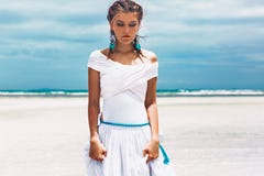 Mulher elegante nova bonita no vestido branco na praia foto de stock Mulher elegante nova bonita no vestido branco na praia foto de stock