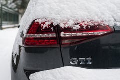 Closeup of Golf GTI sign on rear car parked in the street covered by the snow