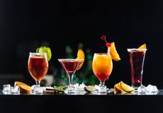 Multi-colored alcoholic cocktails with citrus in glasses of different shapes on the bar. stock photo Multi-colored alcoholic cocktails with citrus in glasses of different shapes on the bar. stock photo