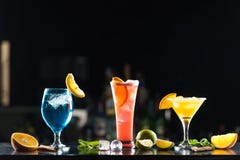 Multi-colored alcoholic cocktails with citrus in glasses of different shapes on the bar. stock photos Multi-colored alcoholic cocktails with citrus in glasses of different shapes on the bar. stock photos