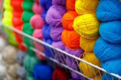Multi-colored textile threads in hand-made reels are displayed for sale in the store stock photography Multi-colored textile threads in hand-made reels are displayed for sale in the store stock photography