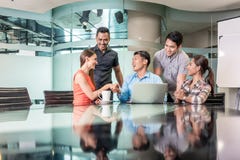 Multi-ethnic team working together on an innovative business project royalty free stock image Multi-ethnic team working together on an innovative business project royalty free stock image