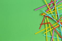 Multicolored cocktail tubes straws on green background stock image Multicolored cocktail tubes straws on green background stock image
