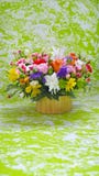 Multicolored flowers bouquet on green, marble stylised background