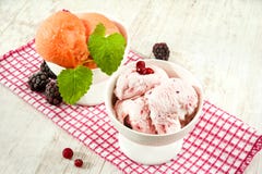 Multicolored fruit ice cream with berries in porcelain bowls stock photos Multicolored fruit ice cream with berries in porcelain bowls stock photos