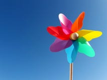 Multicolored pinwheel in front of blue sky stock photos Multicolored pinwheel in front of blue sky stock photos