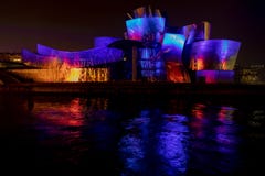 Multicolored show on the facade of the Guggenheim Bilbao museum.