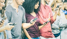 Multicultural friends group using mobile smart phone Royalty Free Stock Photo Multicultural friends group using mobile smart phone Royalty Free Stock Photo