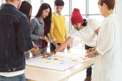 Multiethnic creative team working together, meeting and brainstorming on table in workplace. Startup diversity teamwork brainstorm stock photo Multiethnic creative team working together, meeting and brainstorming on table in workplace. Startup diversity teamwork brainstorm stock photo