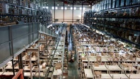Multilevel warehouse with cardboard boxes arranged on the racks, pharmaceutical production