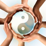 Multiracial Hands Surrounding Yin Yang symbol Stock Photo Multiracial Hands Surrounding Yin Yang symbol Stock Photo