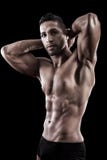 Muscled Man On A Black Background Royalty Free Stock Photos