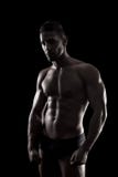 Muscled Man On A Black Background Royalty Free Stock Photo