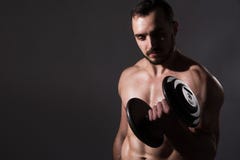 Muscular bodybuilder guy doing exercises with dumbbell stock photography Muscular bodybuilder guy doing exercises with dumbbell stock photography