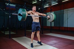 Muscular fitness man preparing to deadlift a barbell over his head in modern fitness center.Functional training.Snatch royalty free stock photography Muscular fitness man preparing to deadlift a barbell over his head in modern fitness center.Functional training.Snatch royalty free stock photography
