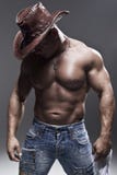 A muscular man in a cowboy hat