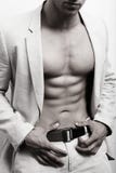 Muscular man with abs and suit