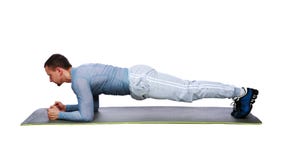 Muscular sportsman practicing yoga on a mat stock images Muscular sportsman practicing yoga on a mat stock images