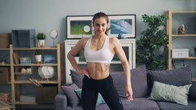 Muscular young lady bodybuilder looking at camera smiling moving fit strong body stock footage Muscular young lady bodybuilder looking at camera smiling moving fit strong body stock footage