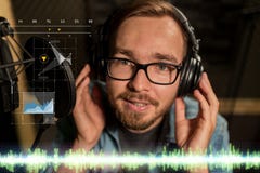 Man with headphones singing at recording studio Stock Photo Man with headphones singing at recording studio Stock Photo