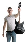Musica e creatività Un giovane bello in una maglietta dà una chitarra elettrica in sua mano Giochilo Struttura orizzontale immagini stock Musica e creatività Un giovane bello in una maglietta dà una chitarra elettrica in sua mano Giochilo Struttura orizzontale immagini stock