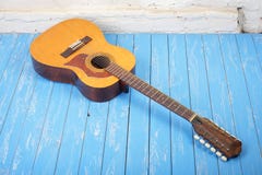 Musical instrument - Twelve-string acoustic guitar brick backgro. Musical instrument - Vintage twelve-string acoustic guitar on a brick background and blue royalty free stock photo Musical instrument - Twelve-string acoustic guitar brick backgro. Musical instrument - Vintage twelve-string acoustic guitar on a brick background and blue royalty free stock photo
