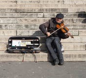 Musician Playing a Violin For Money