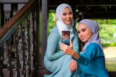 Muslim Malay Women Wearing Hijab And Traditional Costume Are Taking Selfie During Aidilfitri Celebrations At The Terrace Of Stock Image Image Of Holiday Clothing 178169449