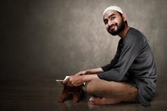 Muslim man reading holy quran