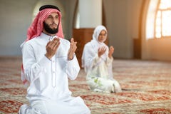 Muslim man and woman praying in mosque Royalty Free Stock Photos Muslim man and woman praying in mosque Royalty Free Stock Photos