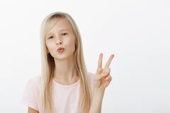 Mwah to my followers, stay updated. Portrait of fashionable confident young girl with natural fair hair, folding lips royalty free stock photo Mwah to my followers, stay updated. Portrait of fashionable confident young girl with natural fair hair, folding lips royalty free stock photo