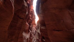 Mysterious Deep Slot Canyon With Curved And Smooth Orange Red Stone Rock Walls