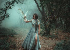 Mysterious sorceress with a bird stock photo Mysterious sorceress with a bird stock photo