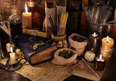 Mystic still life with healing herbs, candles and magic books
