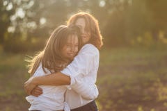 Mãe feliz com sua filha que abraça um adolescente no verão foto de stock royalty free Mãe feliz com sua filha que abraça um adolescente no verão foto de stock royalty free