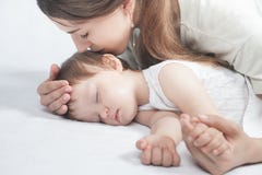 Mãe que beija um bebê Conceito do cuidado foto de stock Mãe que beija um bebê Conceito do cuidado foto de stock