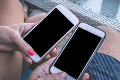 Mãos do homem e da mulher com os smartphones com espaço vazio em um fundo do café da praia, Bali fotografia de stock royalty free Mãos do homem e da mulher com os smartphones com espaço vazio em um fundo do café da praia, Bali fotografia de stock royalty free