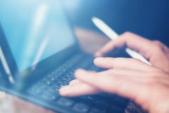 Mãos masculinas que datilografam na estação eletrônica da teclado-doca da tabuleta Equipe o trabalho no escritório ao sentar-se n fotografia de stock Mãos masculinas que datilografam na estação eletrônica da teclado-doca da tabuleta Equipe o trabalho no escritório ao sentar-se n fotografia de stock